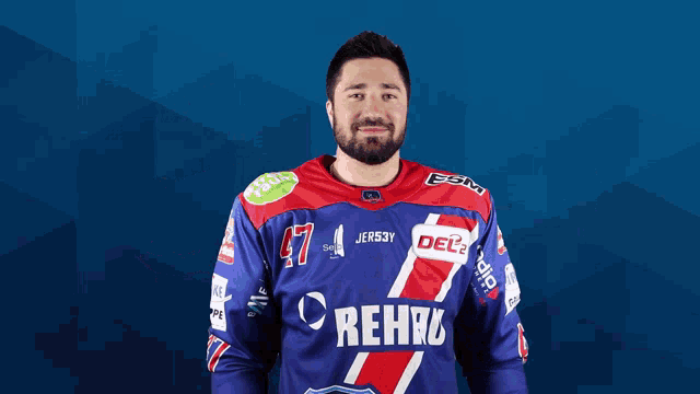 a man wearing a blue and red jersey that says rehau on it