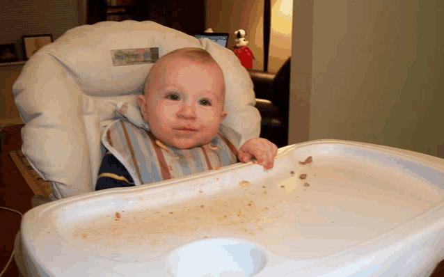 a baby is sitting in a high chair that has the word peg perego on it