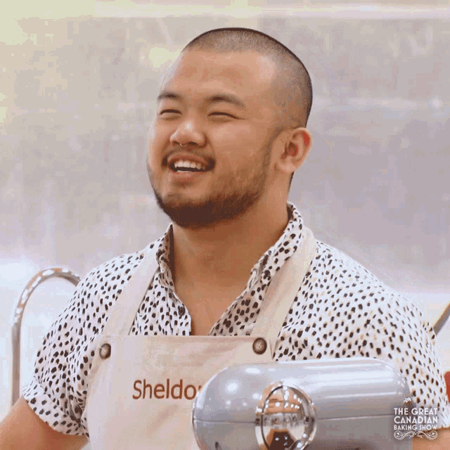 a man wearing an apron that says sheldo