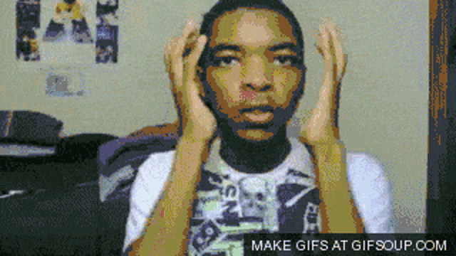 a pixelated image of a man 's face with the words make gifs at gifsoup.com at the bottom