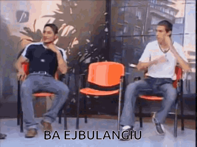 two men are sitting in chairs with the words ba ejbulangiu written on the bottom