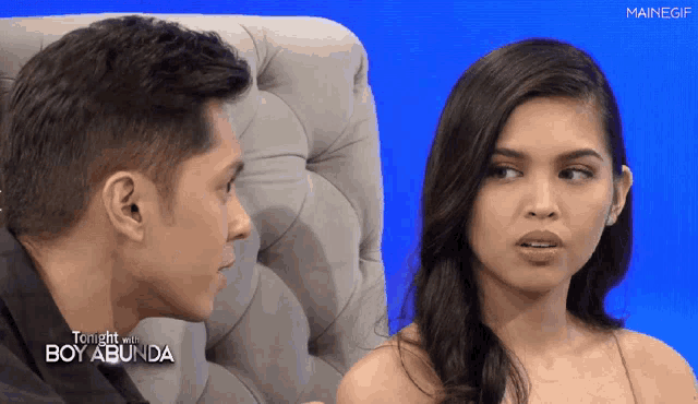 a man and a woman are sitting next to each other on a television show called tonight with boy abunda