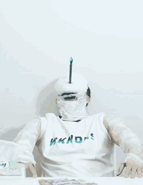 a person wearing a white shirt that says hkds