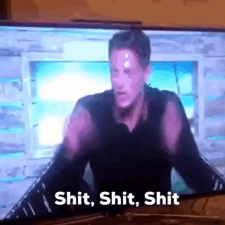 a man is standing in front of a television and saying shit