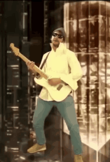 a man wearing sunglasses is playing a guitar while dancing
