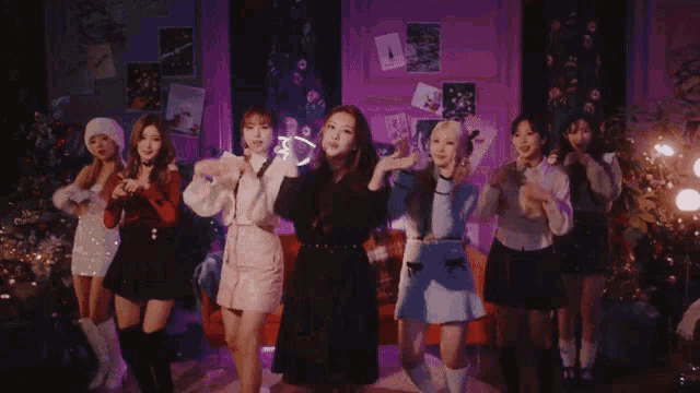 a group of young women are standing next to each other in a room .