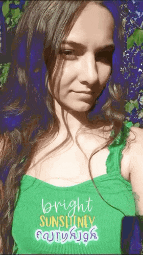 a woman in a green tank top that says bright sunshine