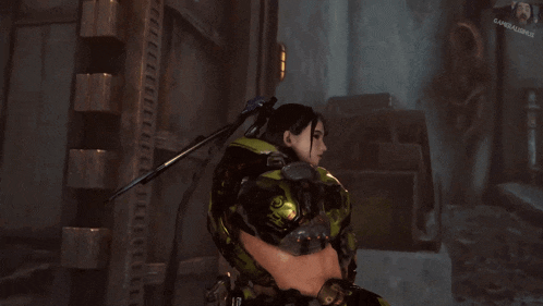 a woman in a green and black armor is standing in front of a screen that says gameshark