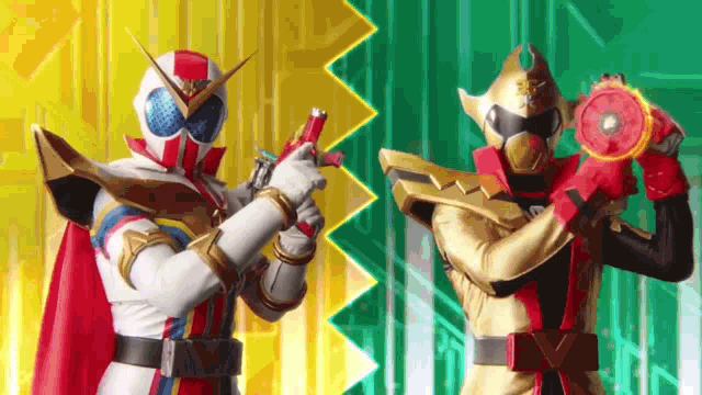 a couple of superheros are standing next to each other holding weapons .