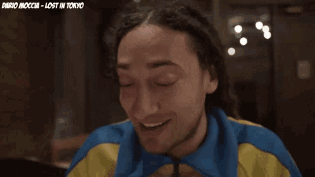 a man wearing a blue and yellow jacket says " noh "