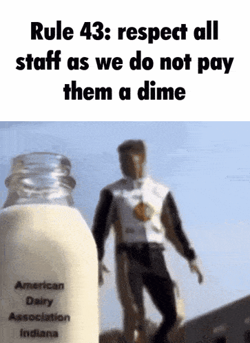 a man standing next to a bottle of milk that says american dairy association indiana on it