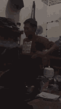a man wearing a red shirt that says " go go go go "