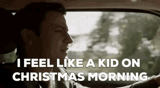 a man is driving a car and saying that he feels like a kid on christmas morning .