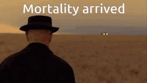 a man in a hat stands in a field with the words " mortality arrived " written above him