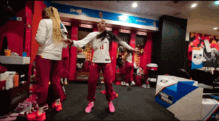 a woman in a white shirt with the number 41 on it is dancing