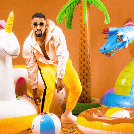 a man standing next to a unicorn and a dragon float