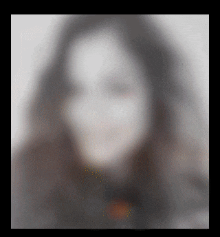 a blurry picture of a woman 's face with long black hair