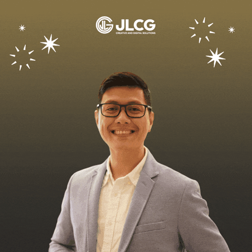 a man is smiling in front of a sign that says jlcg creative and digital solutions