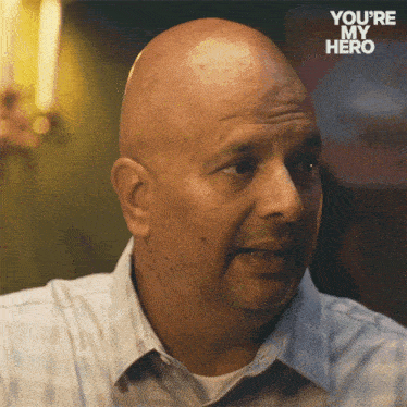 a bald man with the words you 're my hero on the bottom