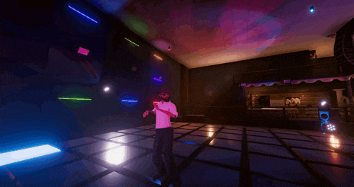 a man in a white shirt is dancing on a dance floor in a dark room