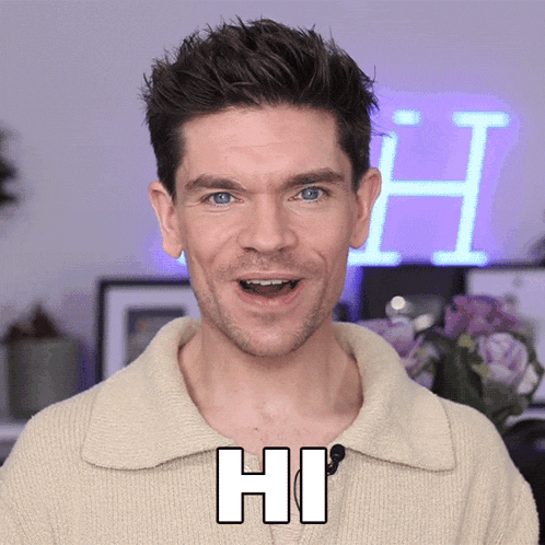 a man says hi in front of a purple h