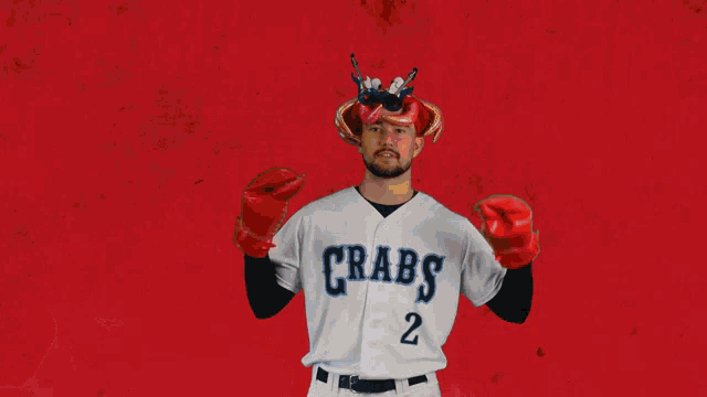 a baseball player for the crabs is wearing a crab hat and gloves