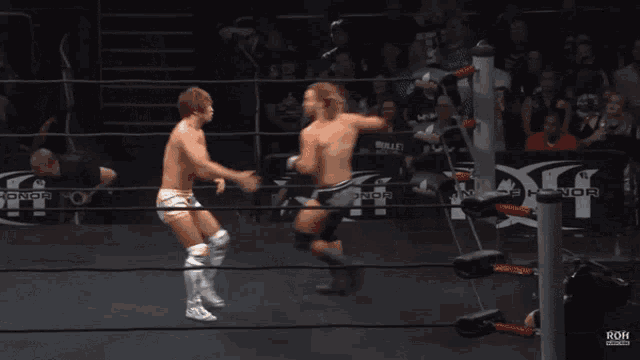 two wrestlers in a ring with the word roh on the side