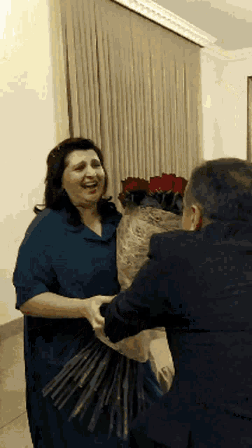 a man giving a woman a bouquet of roses