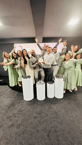 a group of people in green dresses are posing for a picture