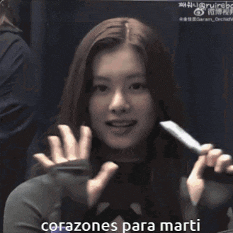 a woman with long hair is smiling with the words corazones para marti below her