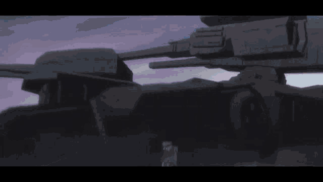 a large black robot with a lot of guns is flying through the air .