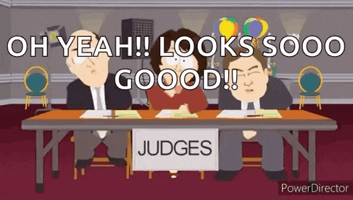 three people are sitting at a table with a sign that says judges .
