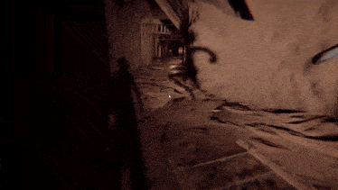 a shadow of a person is cast on a wall in a dark tunnel