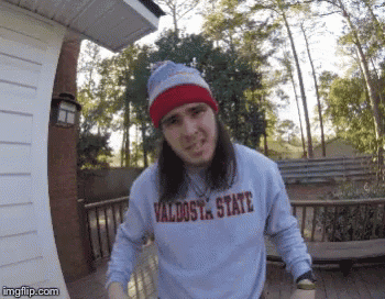 a man wearing a sweater that says valdosta state on it