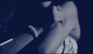 a blurry photo of a person 's arm with a bracelet on it