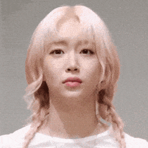 a woman with pink hair is wearing a white shirt and braids