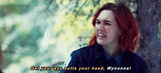 a woman in a police uniform says get your ass outta your head wynonnal .