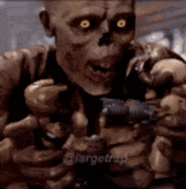 a skeleton is holding a gun in his hands in a dark room .