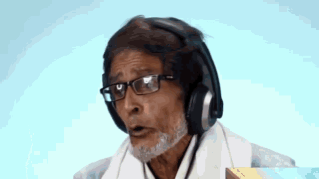 a man wearing glasses and headphones is making a face