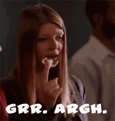 a woman is eating a piece of food and the words grrr argh are on the bottom of the picture .