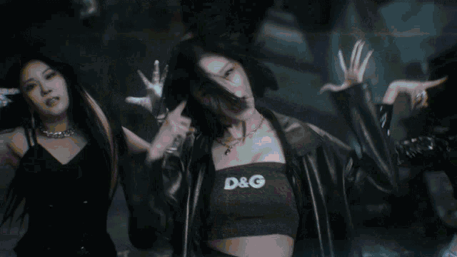 a group of women are dancing and one of them is wearing a blue top that says ' calvin klein ' on it