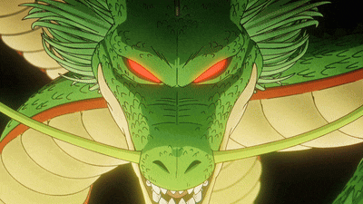 a close up of a green dragon with red eyes and teeth