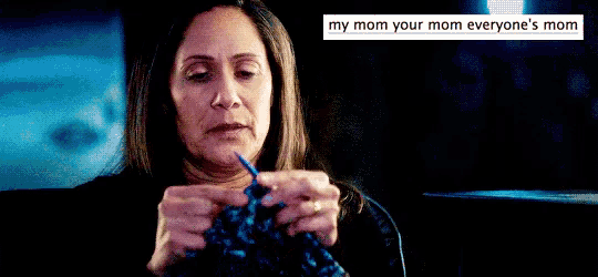 a woman is knitting in a dark room with a caption that says `` my mom your mom everyone 's mom '' .