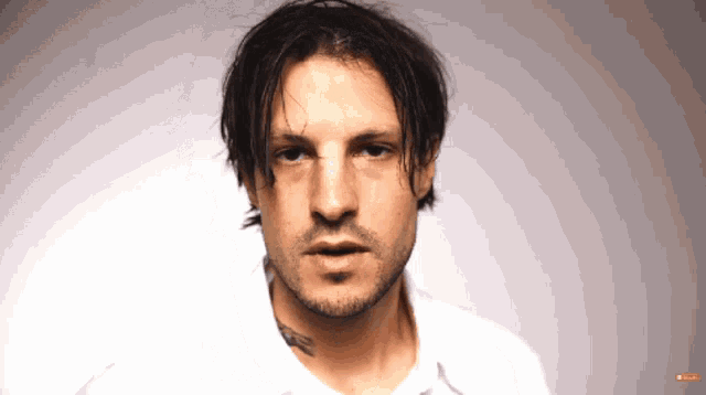 a close up of a man 's face with a red button that says ' subscribe ' on it