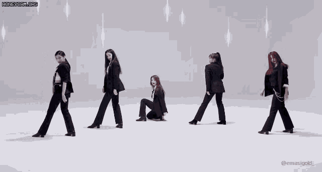 a group of women in suits are dancing together on a white background