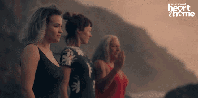 three women standing in front of a mountain with the words super channel heart & home