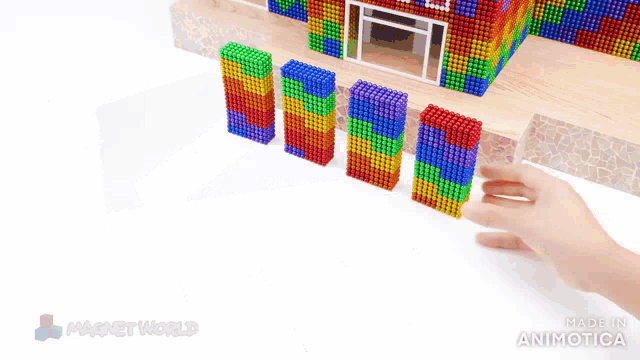 a rainbow colored wall made of magnet balls