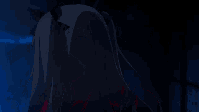 a girl with dark hair and blue eyes is wearing a red jacket