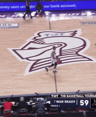 a basketball game is being played on a court with the number 59 on the scoreboard