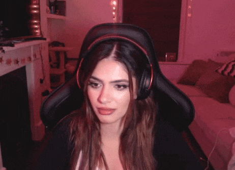 a woman wearing headphones is sitting in a chair in a living room